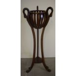 A reproduction mahogany jardiniere stand with swan head decoration plus a mahogany reproduction tab