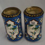 A pair of continental vases with enamelled type decoration has a chip to the rim.