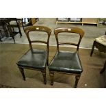 A pair of Victorian oak balloon backed chairs stamped 'John Taylor's of Edinburgh'