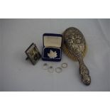 A silver backed hairbrush, silver photograph frame and 4 silver gem set rings with maple leaf brooch