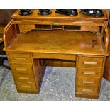 A 19th century oak 'C' top, roll top desk