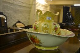 A flower decorated pottery ewer and basin