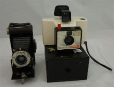 Assorted cameras including a kodak "brownie" , 3 folding bellow cameras and an early polaroid.