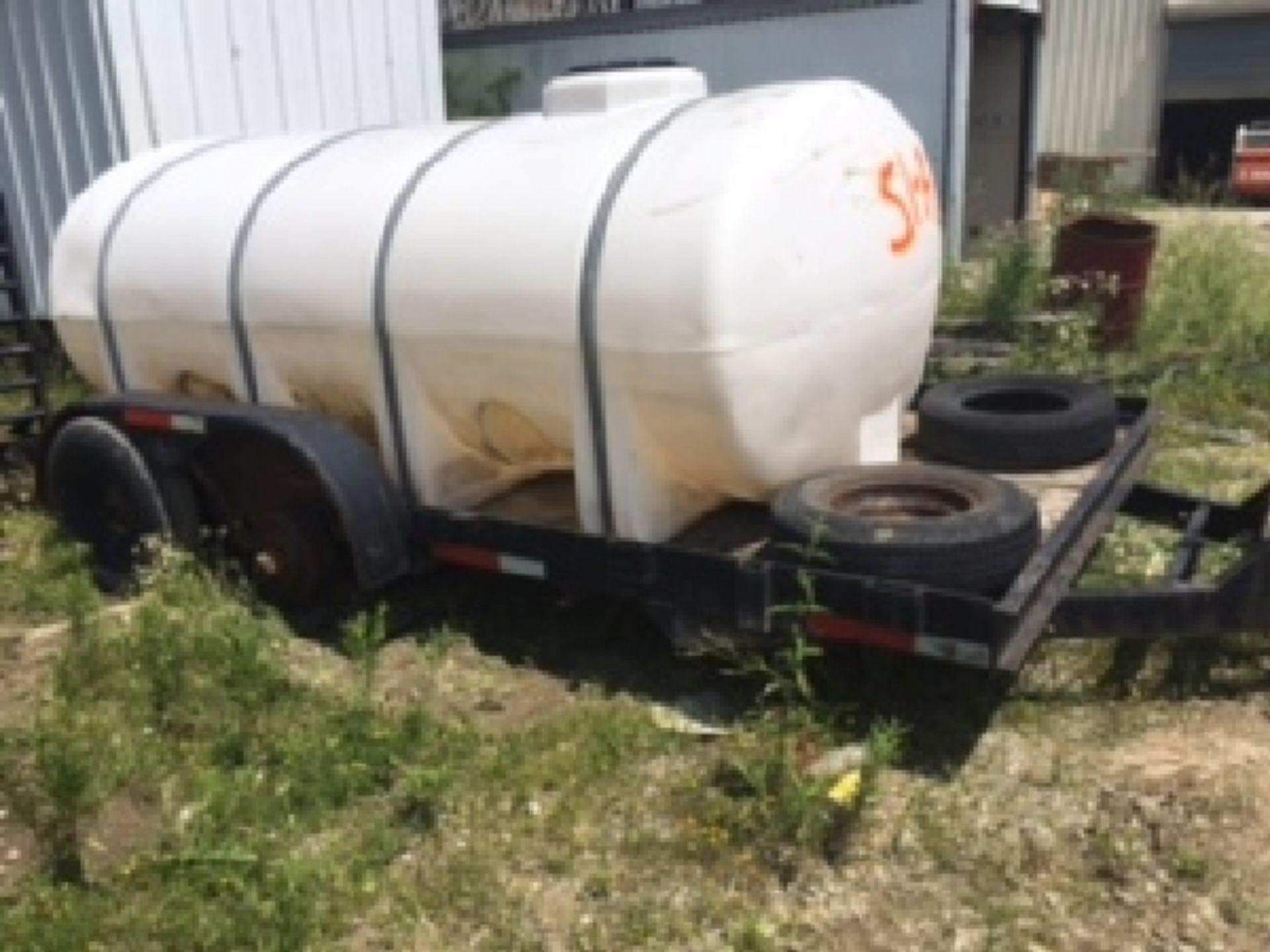 15' x 8.5' flat bed Tandem trailer. Pintel. Ramps.wood floor. Comes with water tank. Needs tire...