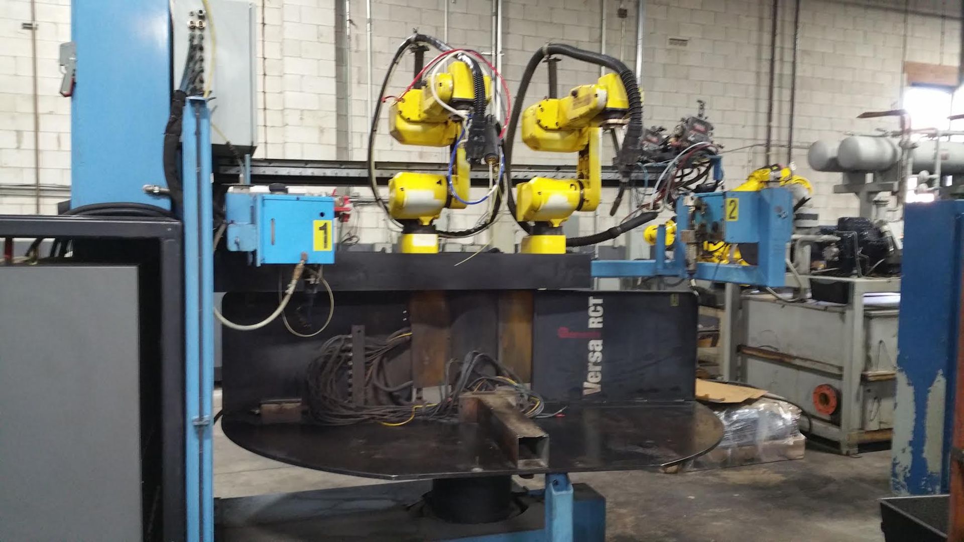 GENESIS 2 POSITION, TWO FANUC ROBOT WELDING CELL, 7300 HOURS, LOCATION ONTARIO CANADA