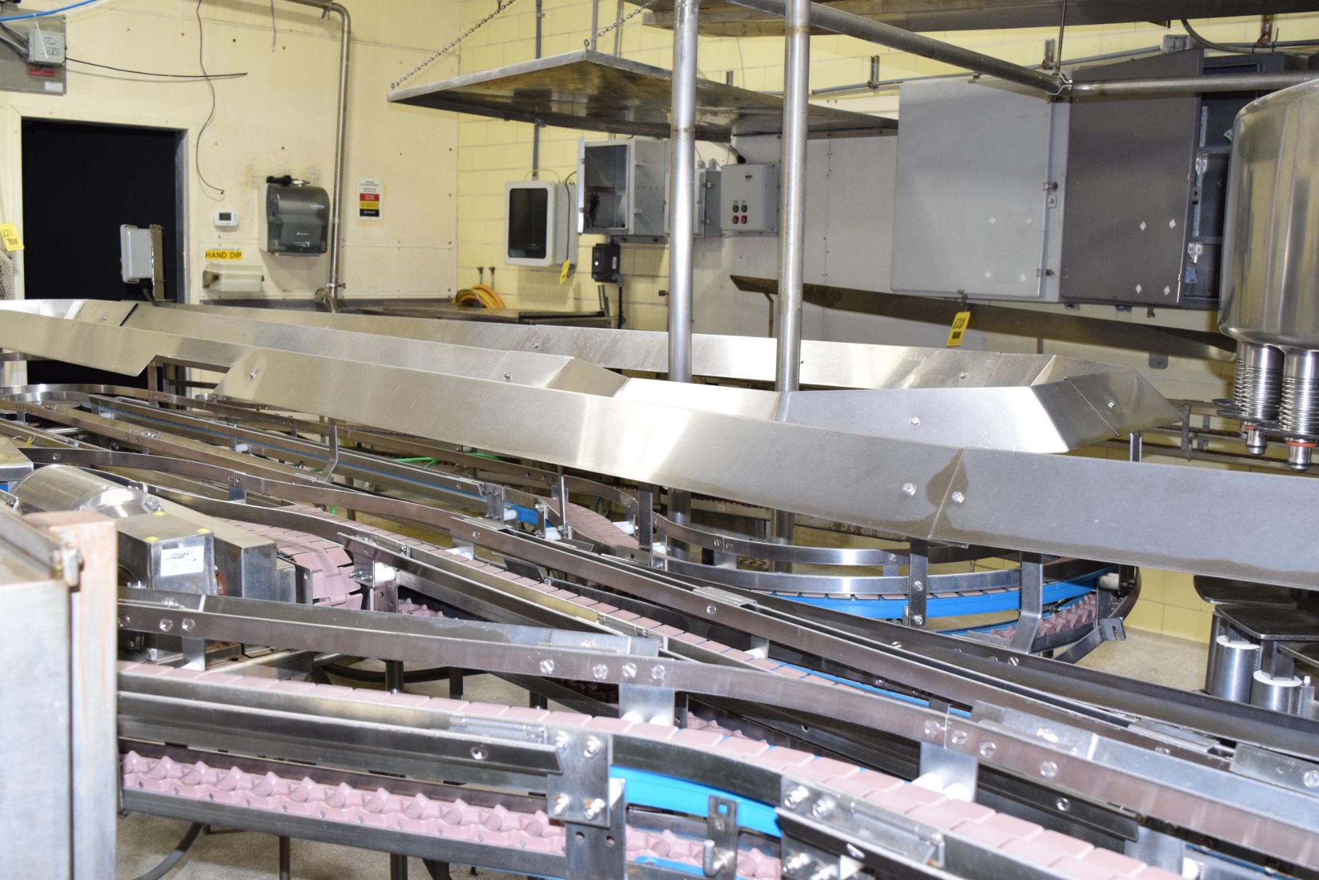 60' (+/-) S/S Frame Product Conveyor with 4-Drives, 180 Degree Turns and 3.25" Wide Plastic Table