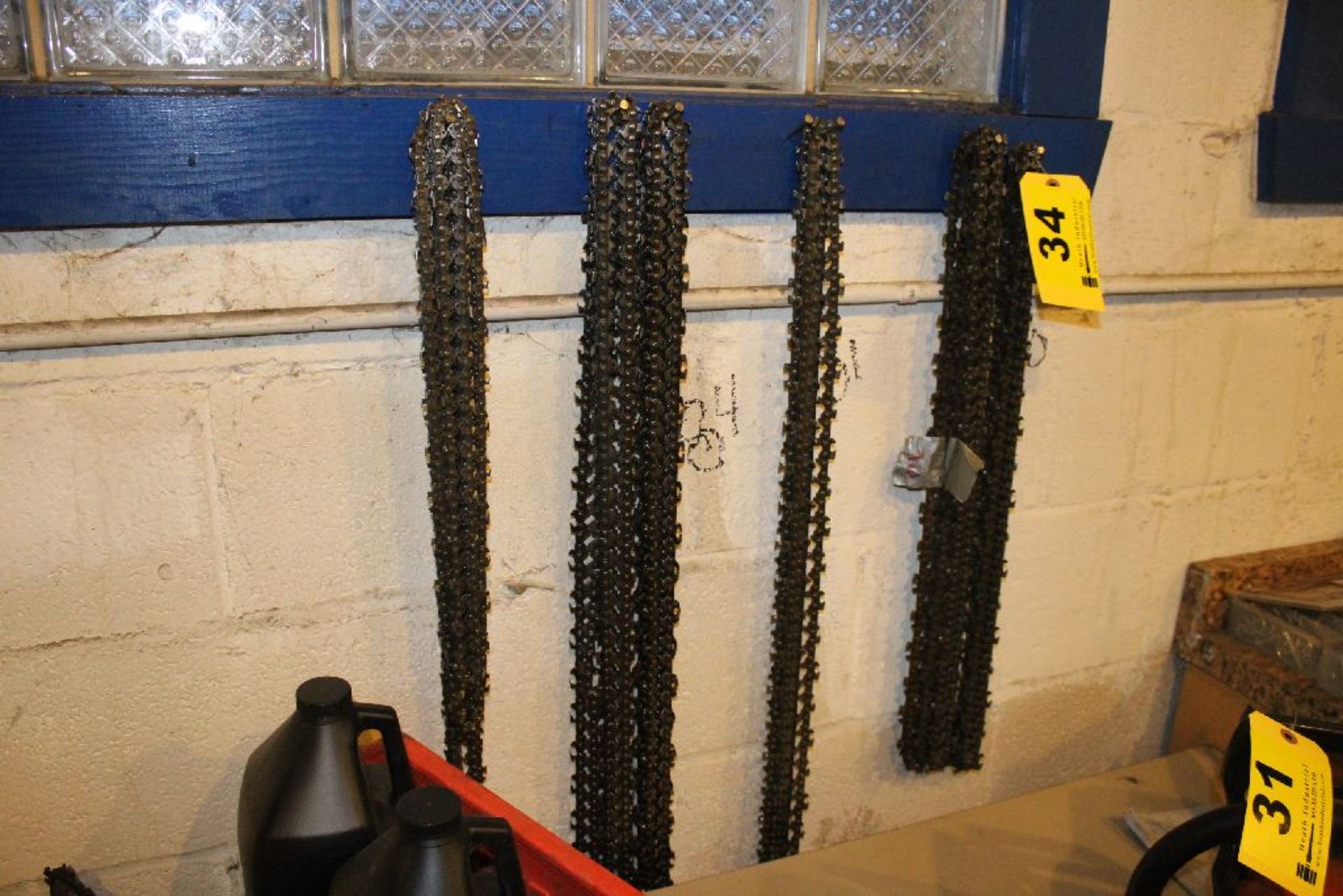 ASSORTED CHAIN SAW BLADES ON HOOKS