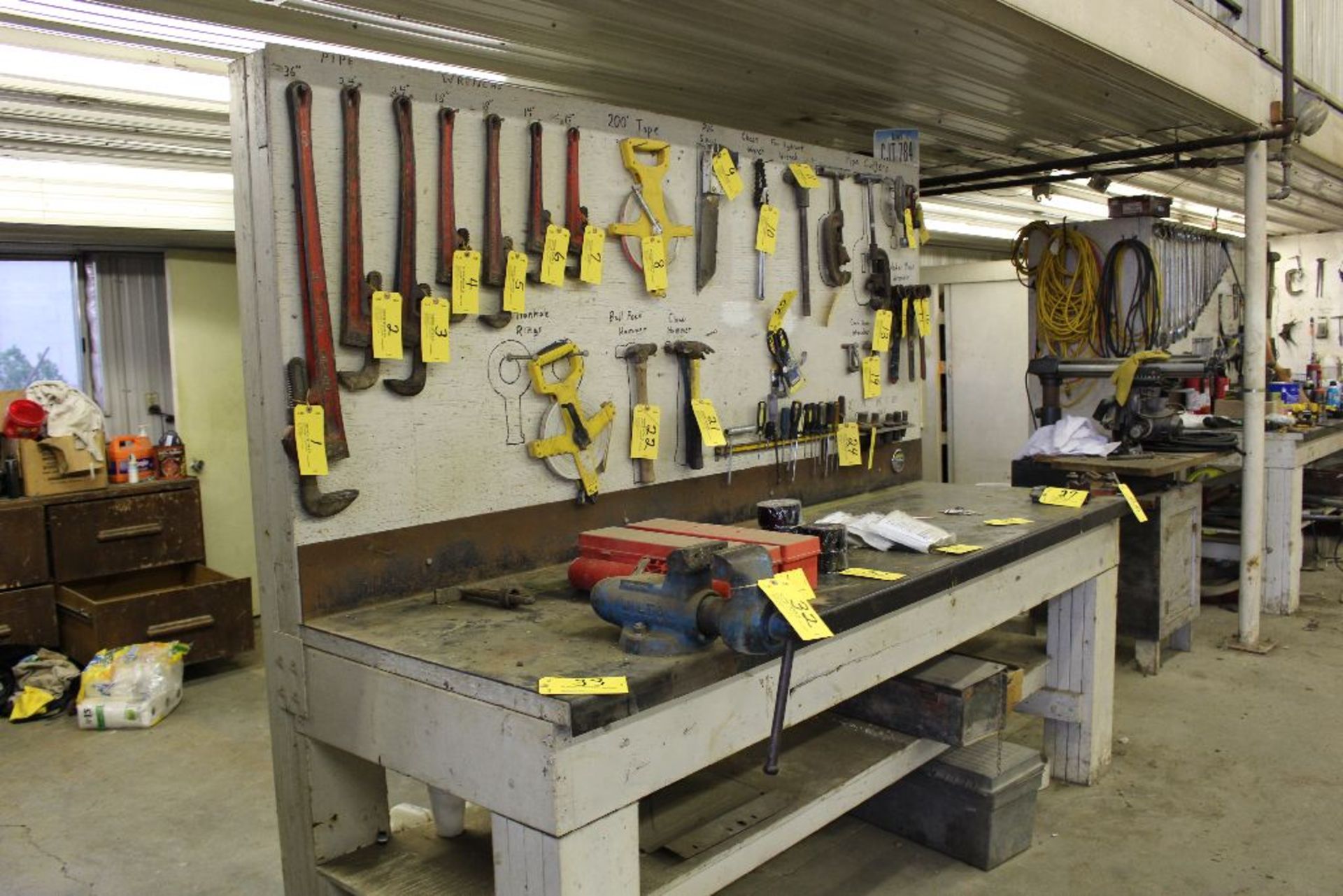 Steel top work bench with backboard.