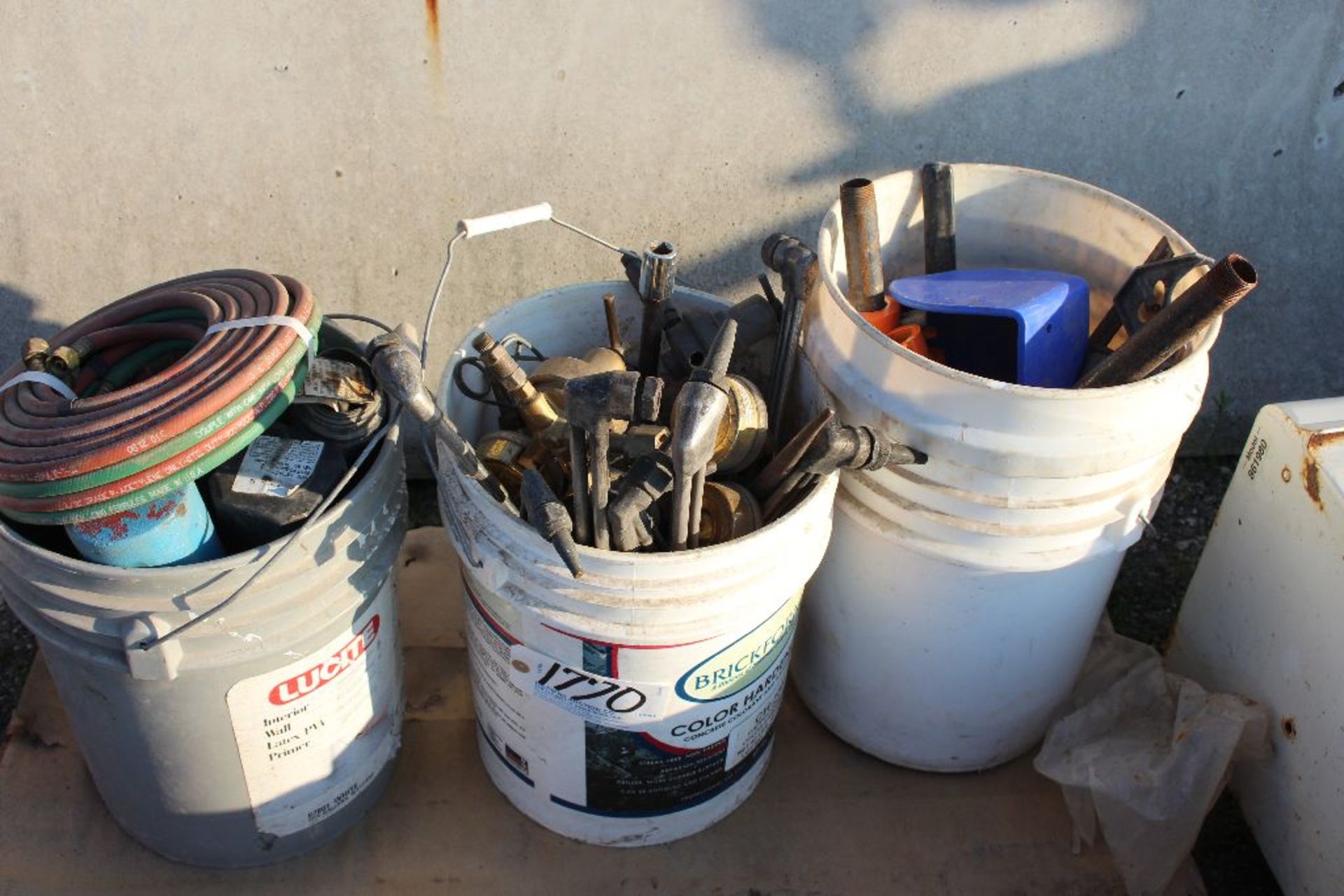 Pails of torch heads, hose, etc.]