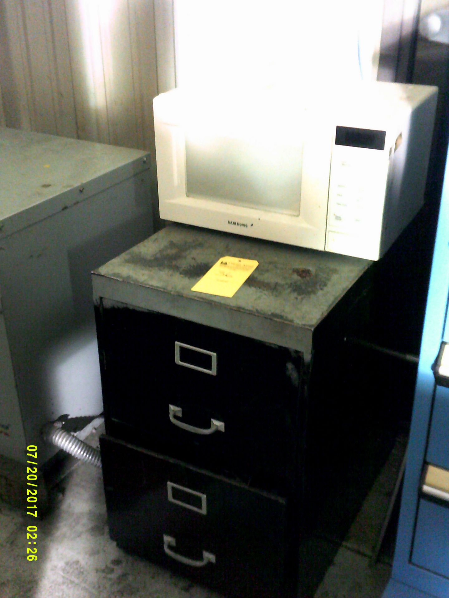 Full size whirlpool refrigerator, miscrowave, black 2 drawer filing cabinet, trash can