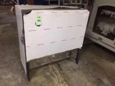 Never used stainless steel three head cafeteria milk dispenser shown with protective paper cover (