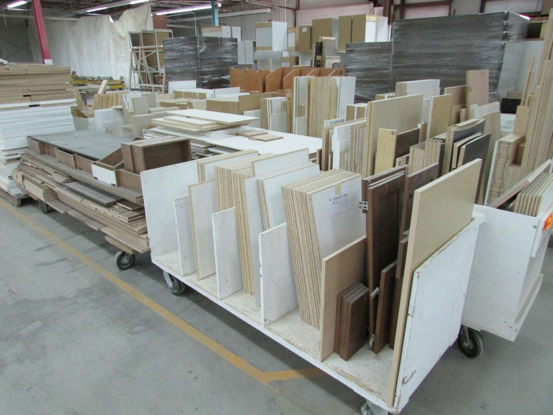 Row of Assorted Wood Panels and Supply Carts