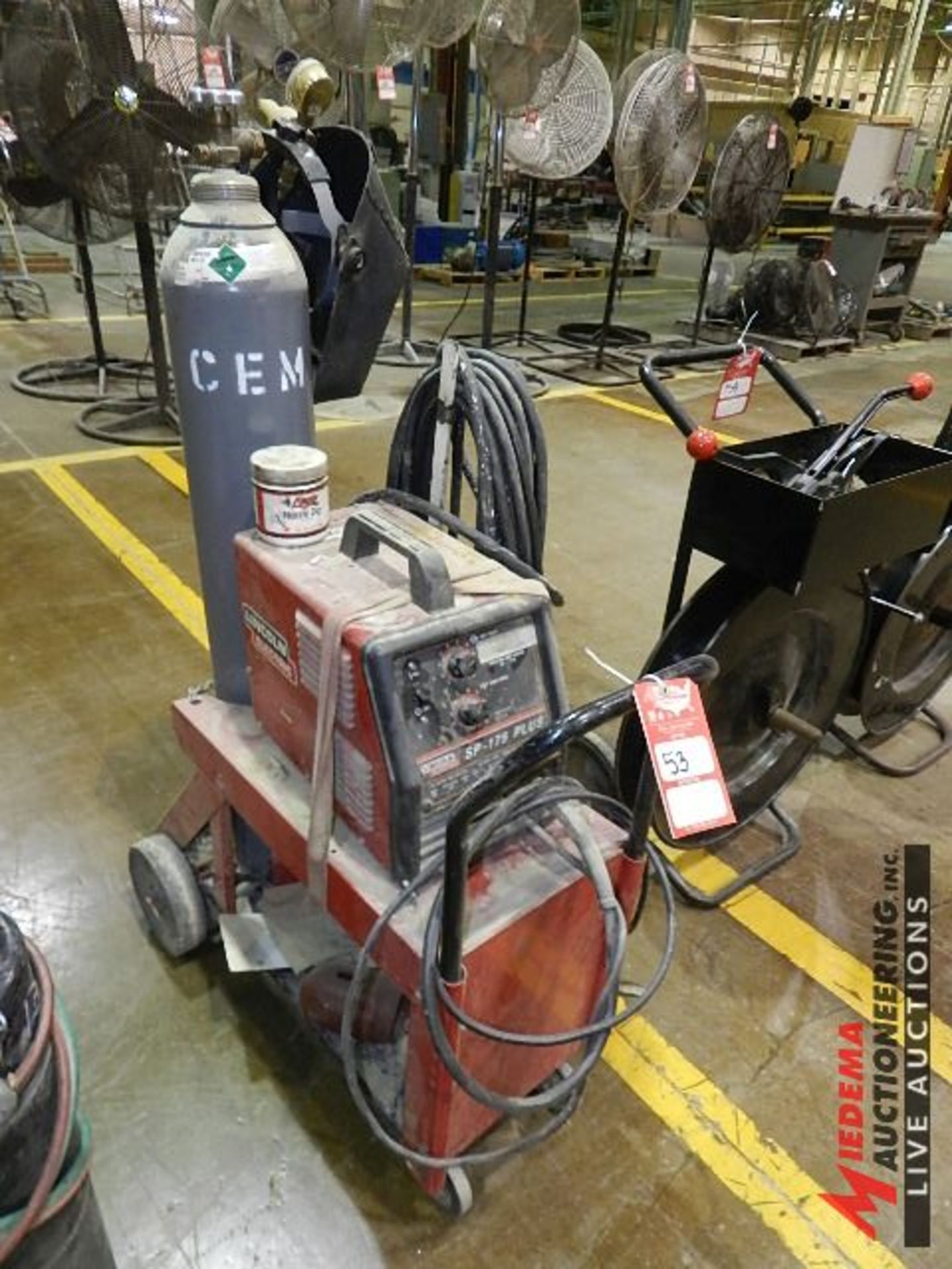 LINCOLN ELECTRIC SP-175+ WIRE FEED WELDER, INCLUDES ROLLING STAND, COMPRESSED GAS TANK, HELMET AND