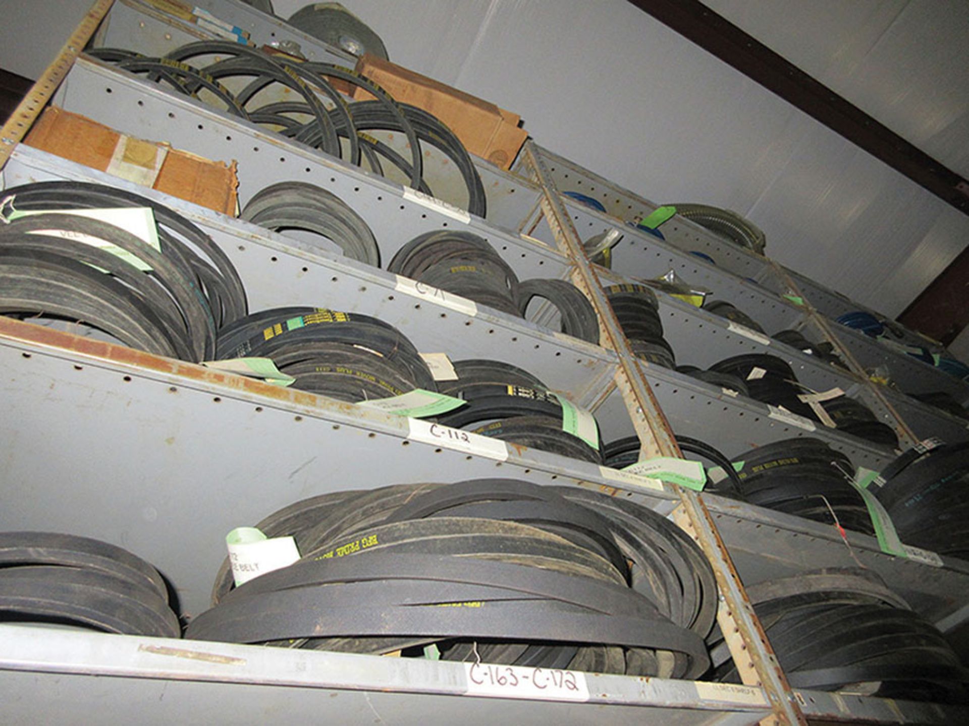 CONTENTS OF TOP PART OF ENTIRE SHELF UNIT: PYLONS, VARIOUS BELTS, HOSES, 3'' X 132'', 4'' X 36'',