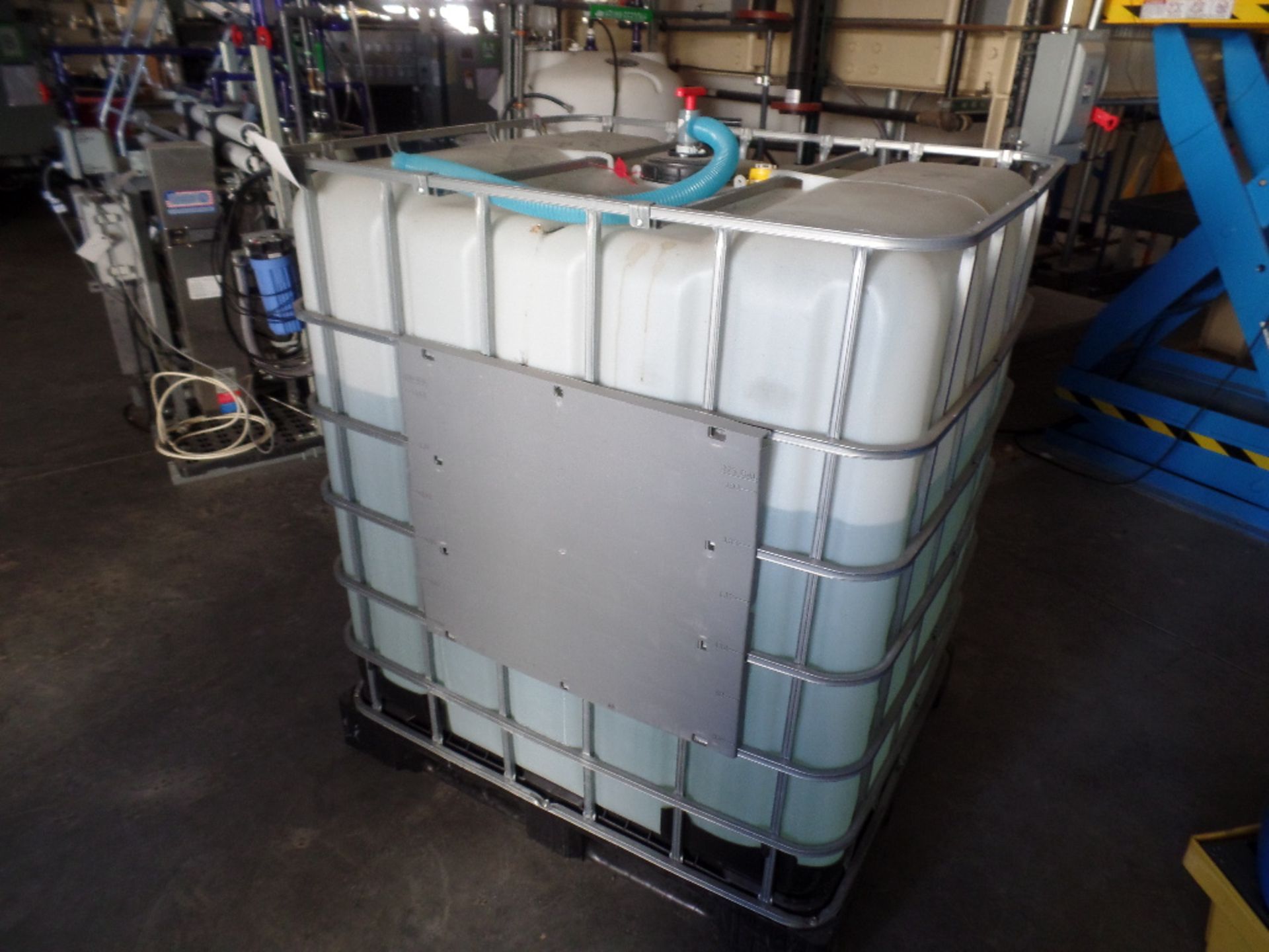 (2) Enclosed Palletized Poly Tanks w/Contents