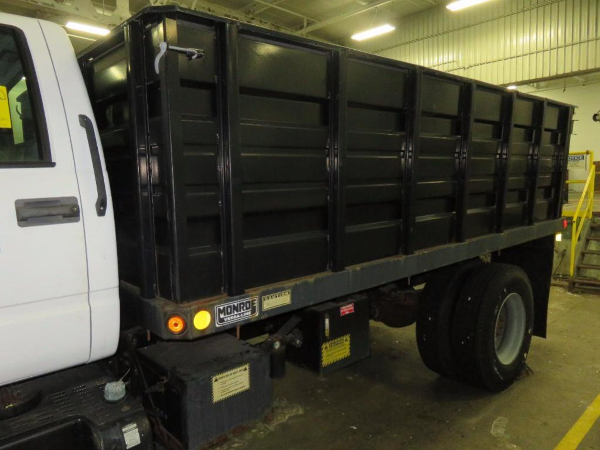 2002 GMC 14 ft. Single-Axle Stake/Dump Truck Model C7500, VIN 1GDL7H1E62J504353 (in loading dock) ( - Image 3 of 7