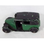 Dinky Toys - an early period Taxi with driver, green body, black roof and running boards,