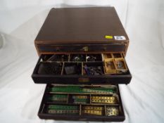 A six drawer wooden chest containing a quantity of vintage Meccano