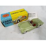 Corgi Toys - a Triumph TR3 Sports Car metallic green with red seats # 305 in original box,