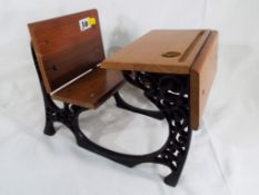 A cast iron and wood doll's school desk, approx.
