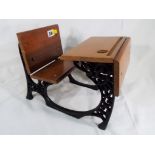 A cast iron and wood doll's school desk, approx.