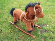 A child's rocking horse with bridle,