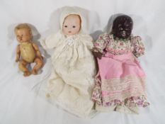 3 vintage dolls. One has papier mache head and stuffed body. A "Reliable" doll, made in Canada.