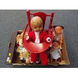 Dolls - a vintage dressed doll with glass eyes and jointed limbs sitting in a wooden high chair,