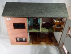 A 1950's wooden, furnished dolls house measuring 50 cm x 64 cm x 27 cm.