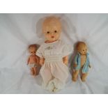 A quantity of three dolls to include one by Kader marked to the back with a globe and the letters