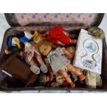 A good lot to include a suitcase containing a quantity of dolls to include a celluloid doll,