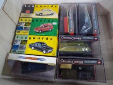 A small collection of boxed diecast models comprising three Vanguard 1:43 scale,