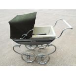 A child's vintage doll's pram by Silver Cross