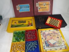A vintage selection of boxed games to include 'Check-a-Peg',