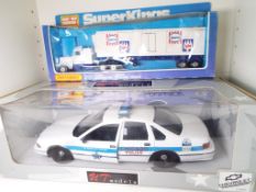 UT Models - a 1:18 scale model Chicago Police Car and a Matchbox SuperKings model Peterbuilt