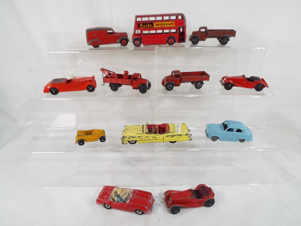 Dinky Toys - A collection of diecast model motor vehicles by Dinky to include, Jaguar, MG Midget,