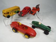 A tinplate Pocketoy Coach with clockwork mechanism, a red clockwork tinplate and plastic towtruck,