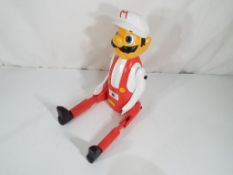 A good quality carved wooden hand-painted shelf puppet depicting Mario.