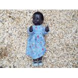 Pedigree - a mid 20th century celluloid black doll with walking mechanism, sleeping eyes, approx.