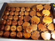 A quantity of approx twenty seven carved wooden trinket boxes in the form of apples and a further
