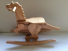 Two wooden carved children's rocking dinosaurs,