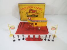 Matchbox by Lesney - a Matchbox Garage, showroom and service station , two sets of Petrol Pumps.