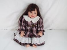 Reborn Doll - a good quality dressed doll (lifelike) with open mouth revealing two bottom teeth,