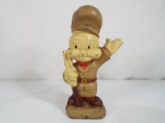 A cast iron money bank in the form of Elmer Fudd