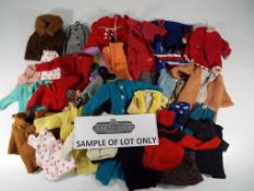 A quantity of vintage dolls clothes some Sindy branded to include coats, trousers, jeans, jackets,