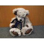 A mohair teddy bear with jointed limbs and leather pants, stitched nose, plastic eyes,