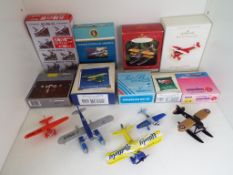 A collection of miniature model aeroplanes to include Schabak, Corgi and others,