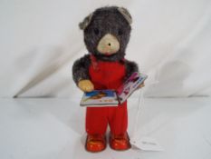 A clockwork tinplate Cubby The Reading Bear toy ca 1960's,