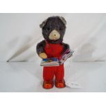 A clockwork tinplate Cubby The Reading Bear toy ca 1960's,