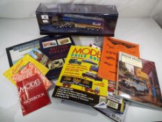 A Corgi modern truck ERF EC series in a perspex presentation case and a quantity of books and